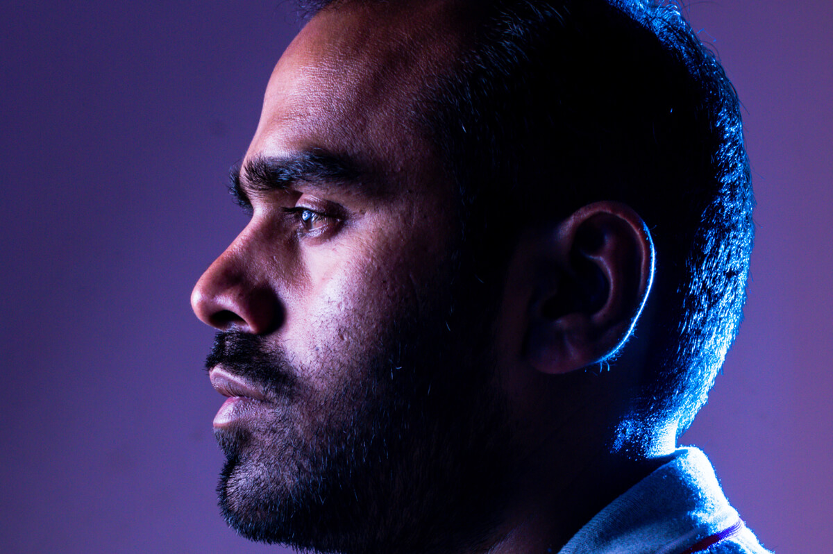 side headshot of a man named Mohan Muruge in front of a purple backdrop